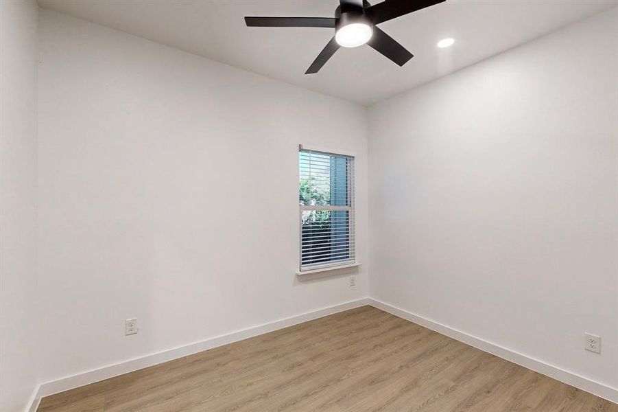 Empty room featuring light wood-type flooring and ceiling fan