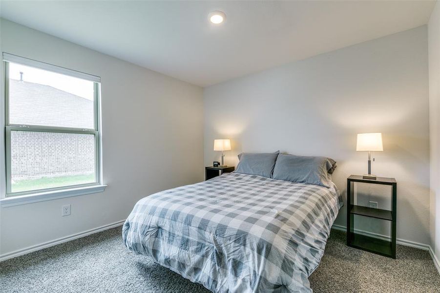 Bedroom featuring dark colored carpet