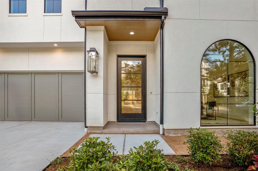 Beautiful low-maintenance landscaping and a covered patio leads to your oversized wrought iron front door.