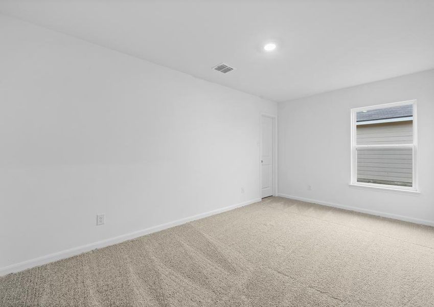 A secondary bedroom with carpet