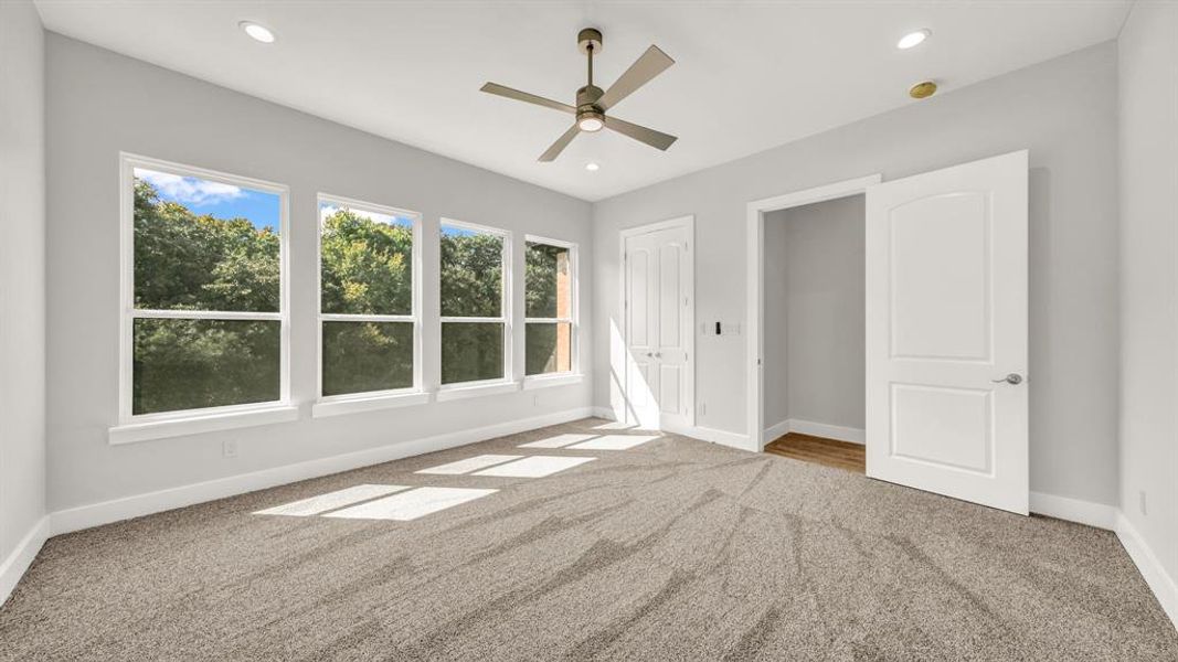 Unfurnished bedroom featuring ceiling fan and carpet flooring