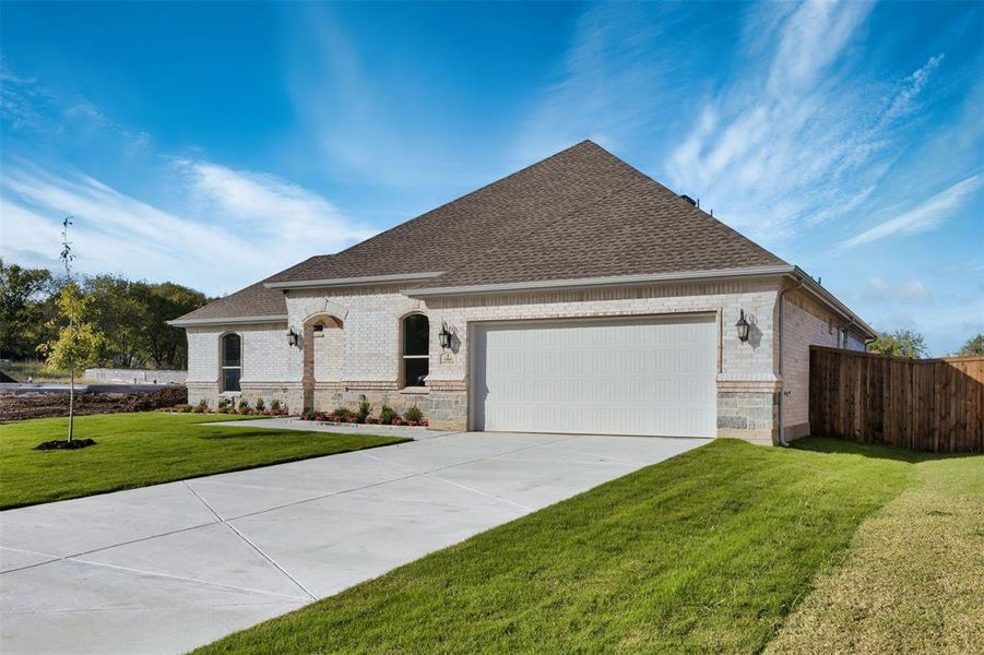 View of front of home featuring a garage and a front lawn