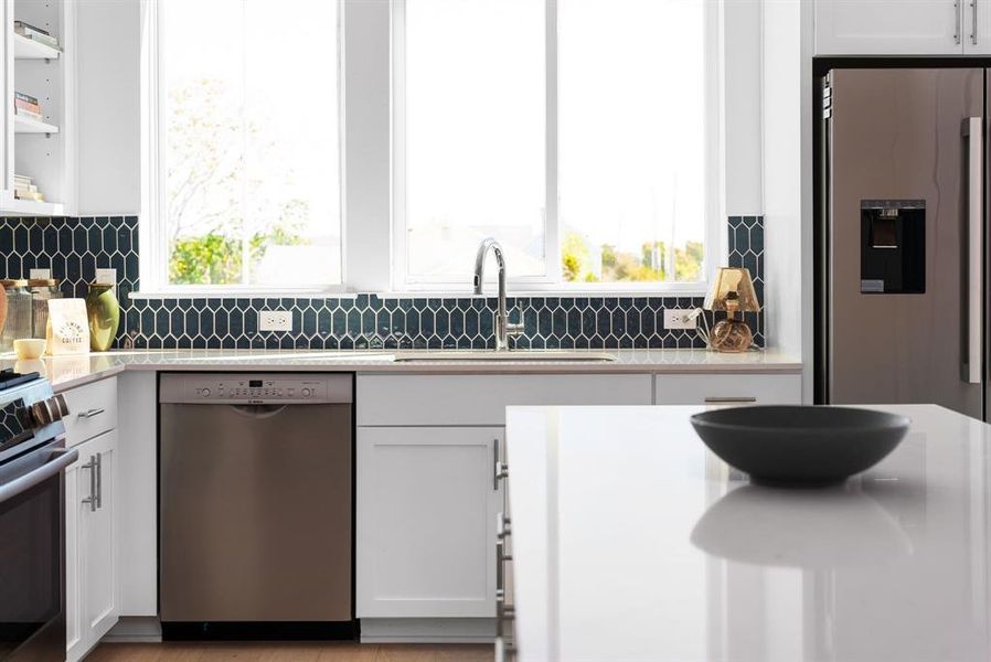 Bright, functional kitchen with modern finishes and natural light pouring through large windows.