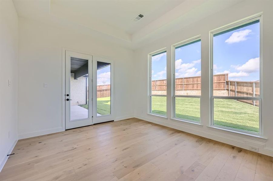 Doorway featuring a healthy amount of sunlight and light hardwood / wood-style floors