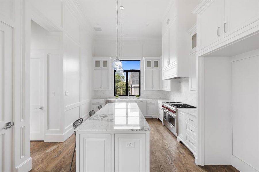 High-end luxury details include such features as imported marble countertops and backsplash, glass-front cabinets, and under-cabinet lighting and outlet strips Image from previously completed home in the community.