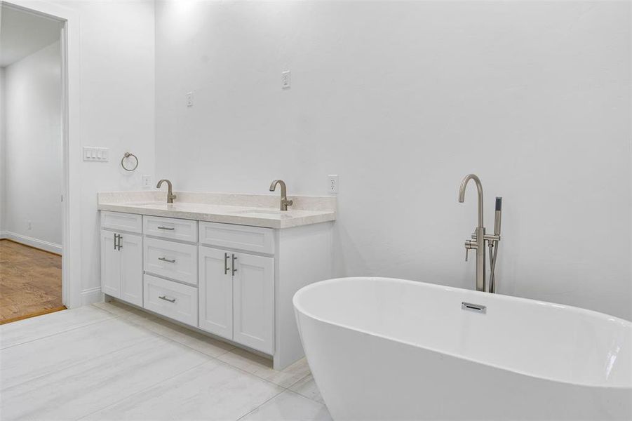 Bathroom featuring a bath and vanity