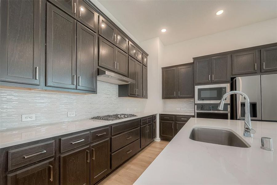 Kitchen includes stainless steel appliances, gas stovetop, built-in oven & microwave, pots & pans drawers, & plenty of cabinetry for your preparation, cooking, & entertainment needs.