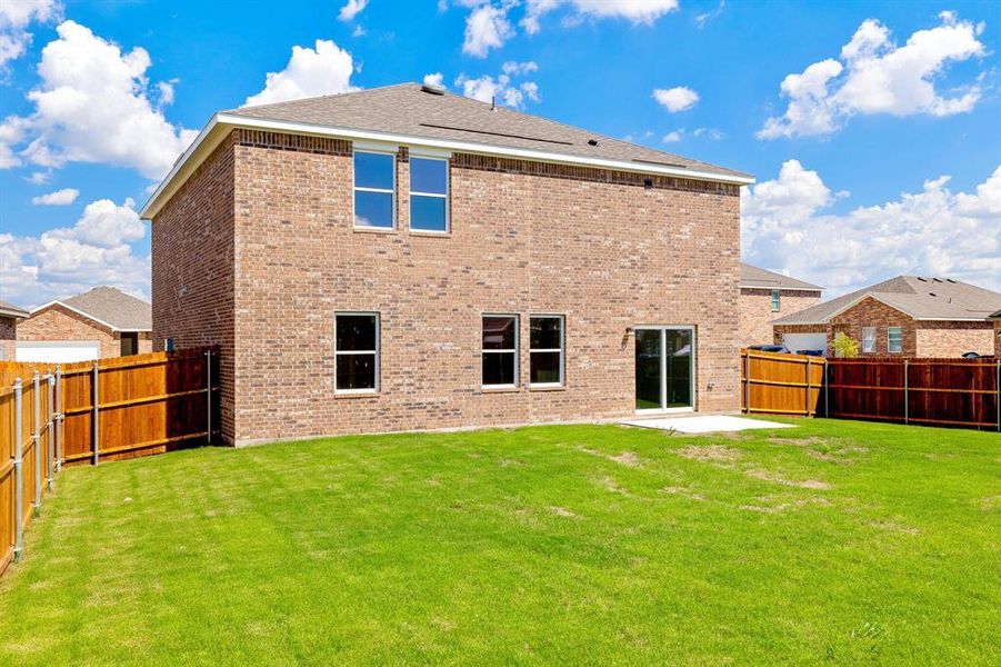 Back of property with a patio and a lawn