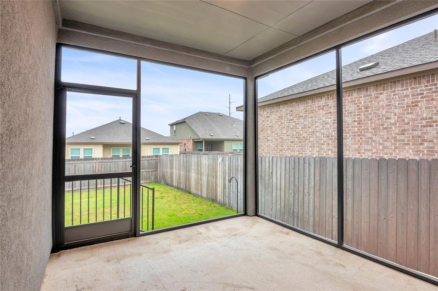 Enjoy cool morning or evenings in this screened-in patio located in the backyard.