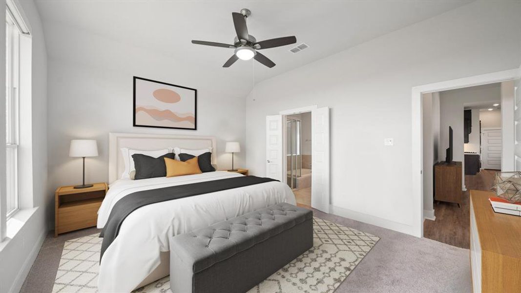 Come relax in the primary retreat with brand new plush carpet, a ceiling fan, and direct access to your ensuite primary bathroom! *This photo has been virtually staged