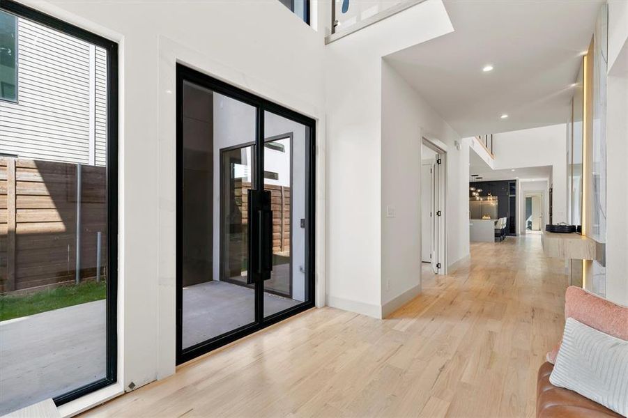 Hallway featuring light hardwood / wood-style floors and a healthy amount of sunlight