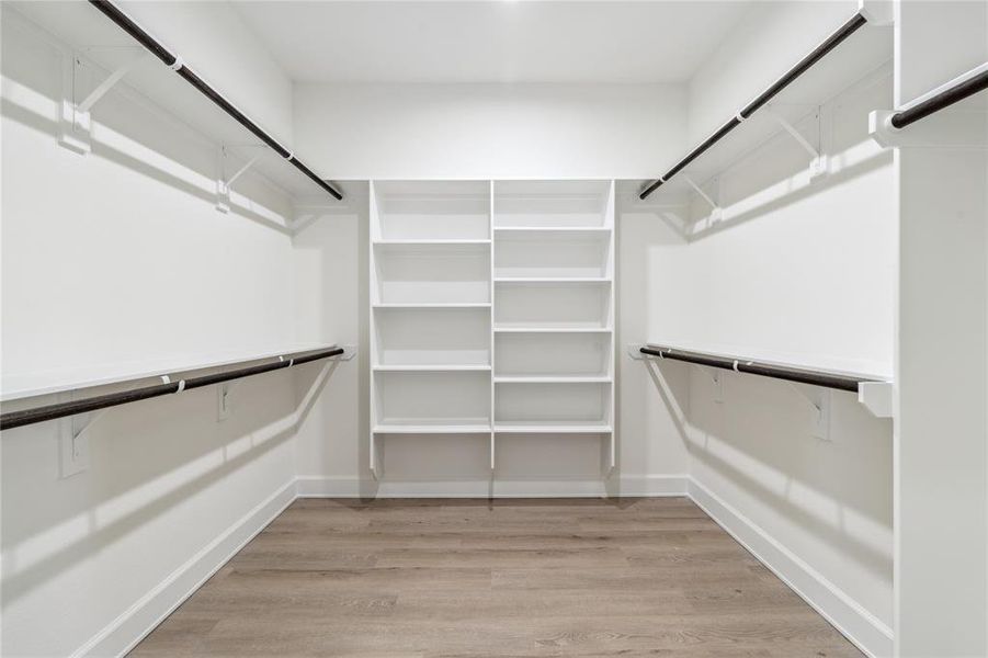 An oversized walk-in closet with shelves, offering ample storage space for your wardrobe essentials. Perfectly designed to enhance organization and convenience in your daily routine.