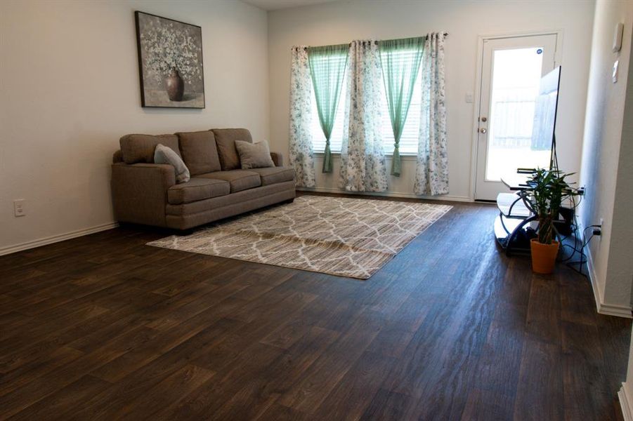 Spacious living area with beautiful vinyl grey plank floor.