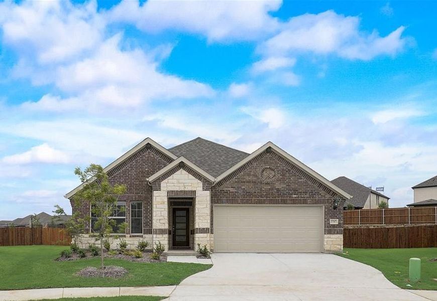 View of front of home with a front yard and a garage