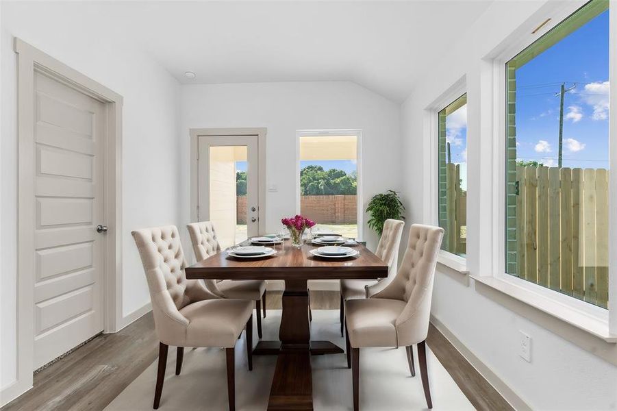The Casual Dining has walls of Windows allowing all that Natural Lighting and amazing View of that Covered Patio and your Backyard for all your Outdoor Living! **Virtually Staged Photo** **Image Representative of Plan Only and May Vary as Built**