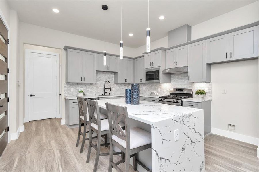 Kitchen and Island area with tons of storage and soft close drawers.