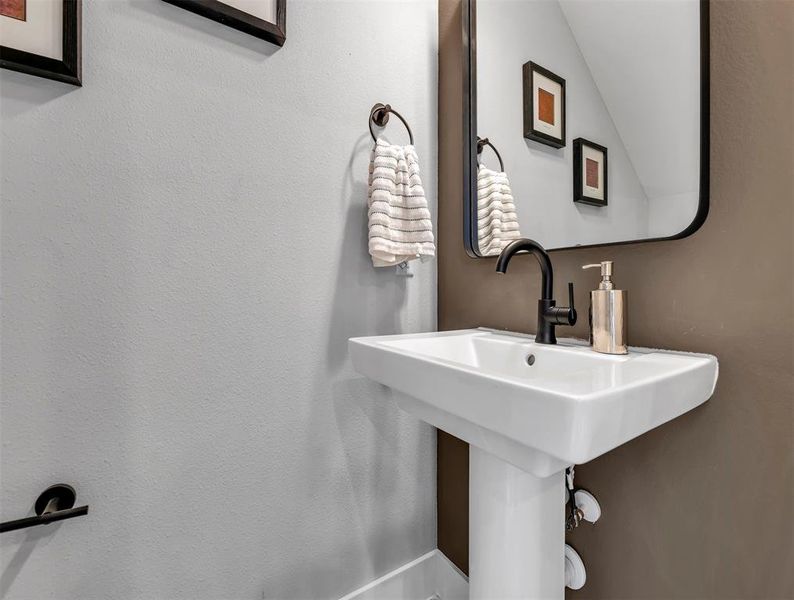 Powder bath is conveniently located off the kitchen for guest and personal use.
