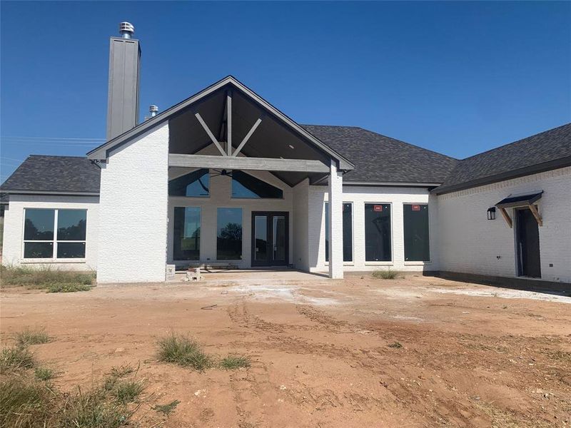 Back of house with ceiling fan and french doors