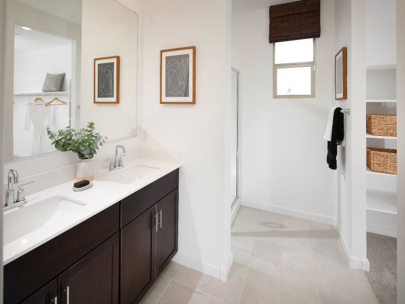 Dual vanities and a spacious walk-in closet closet complement the ensuite bathroom.