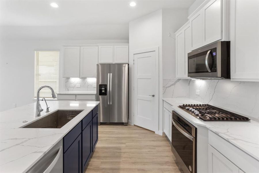 Under cabinet lighting and recessed lighting ensure that the kitchen is well-lit for cooking tasks, while also adding ambiance and highlighting the beauty of the countertops and backsplash.