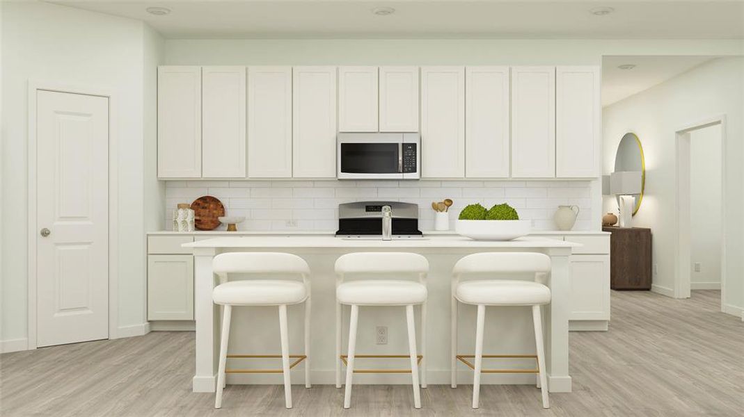 Kitchen featuring stove, white cabinets, light wood-type flooring, and tasteful backsplash