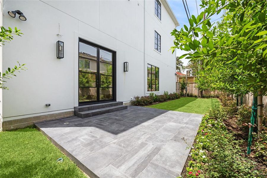 The bonus of being an end unit you get to step out from the living room to this large patio and sprawling back yard with beautiful landscaping and room to lounge and run and play!  Who will like it more? You or your pets?!