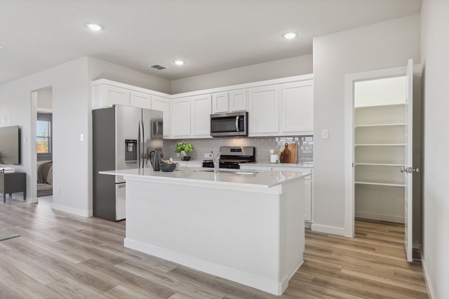 Kitchen in the Willow home plan by Trophy Signature Homes – REPRESENTATIVE PHOTO