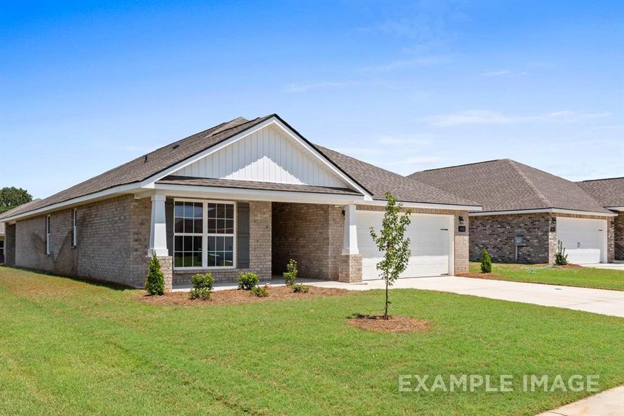 View of front of house with a garage and a front yard