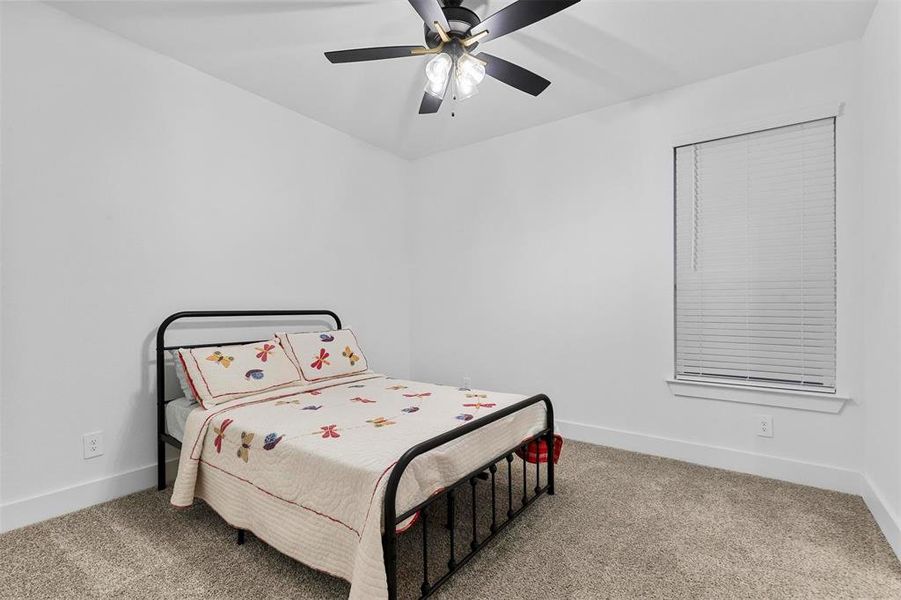 Bedroom with carpet and ceiling fan