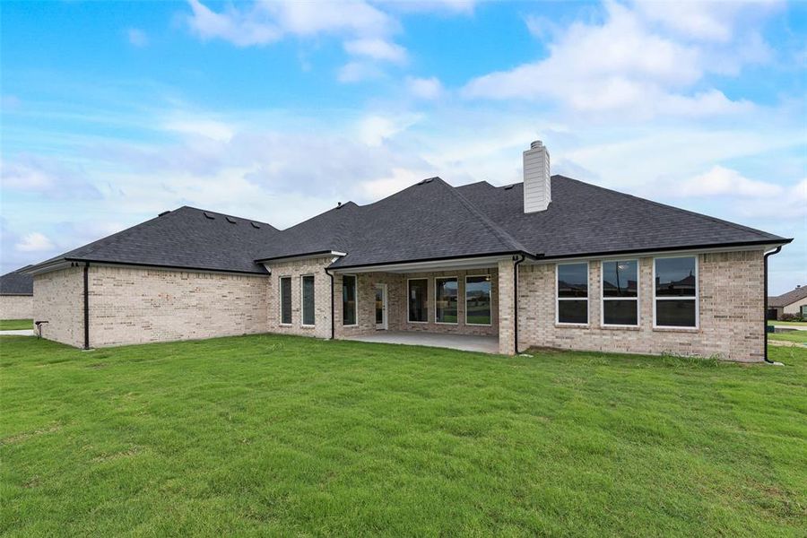 Rear view of property with a patio and a yard