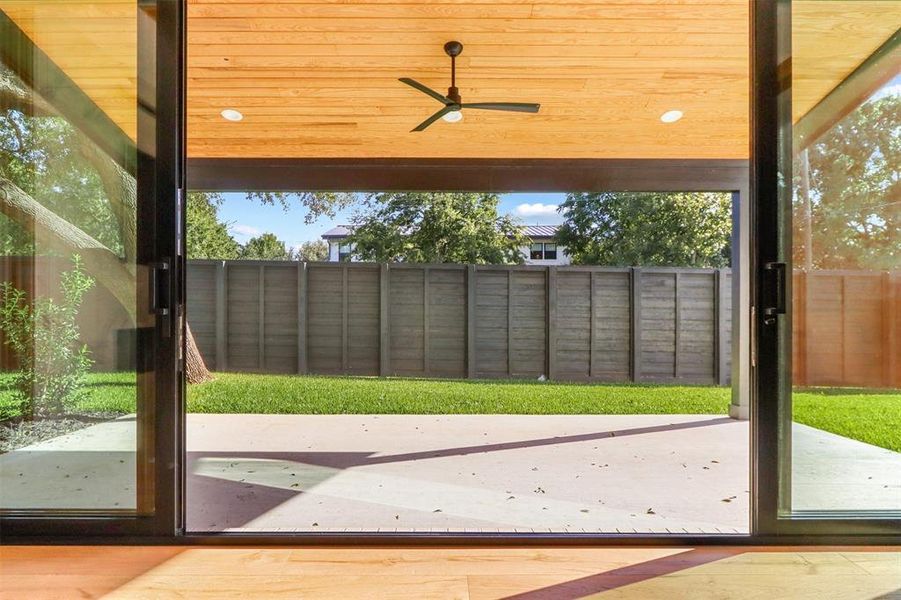 Doorway featuring ceiling fan, wooden ceiling, and hardwood / wood-style floors