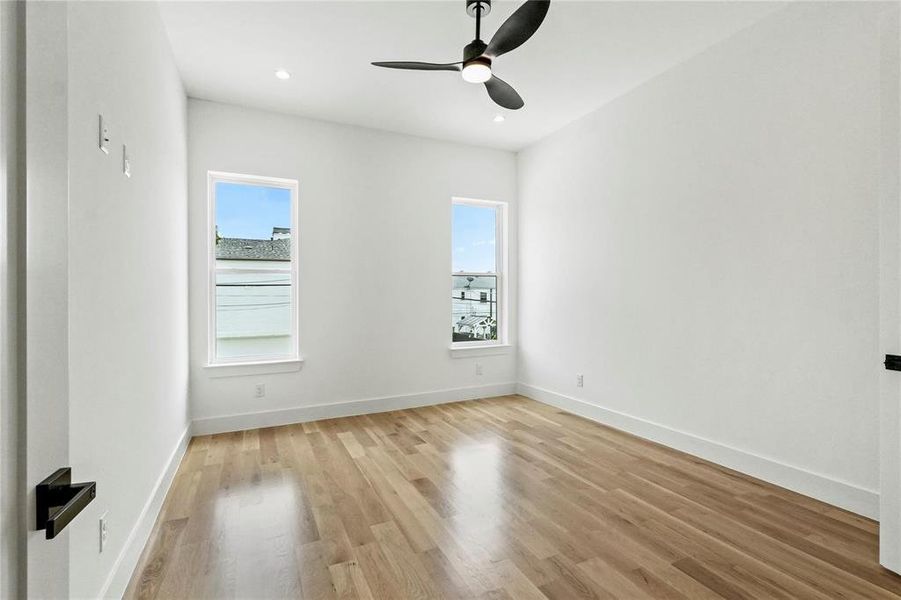 Unfurnished room with light hardwood / wood-style flooring and ceiling fan