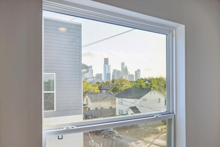 Enjoy a stunning view of the downtown skyline right from your kitchen window. This picturesque sight blends the charm of the neighborhood with the modern appeal of the cityscape beyond.