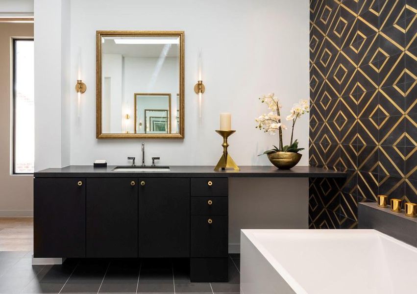 The master bath displays Barden's familiar out-of-the box design with black encaustic tile infused with Japanese brass.