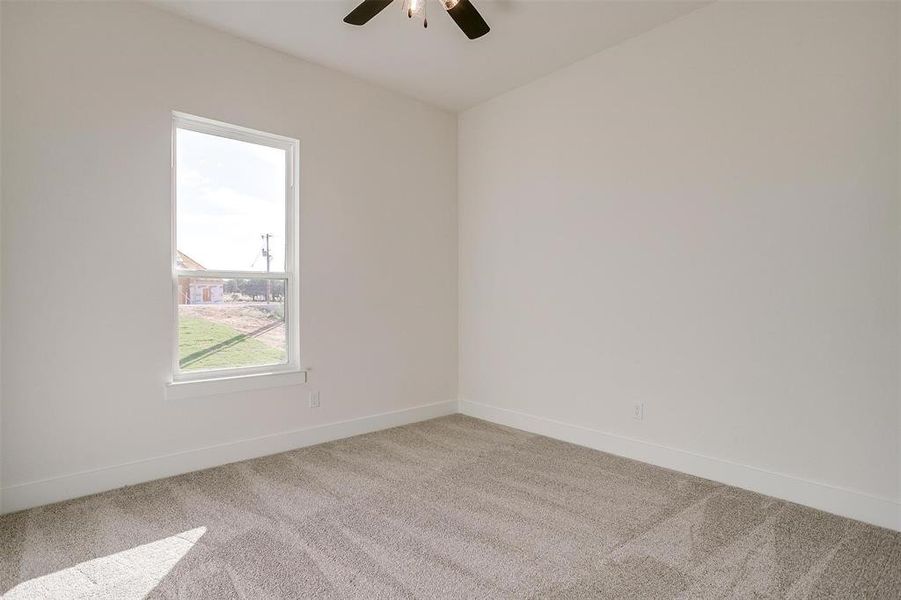 Unfurnished room with light carpet and ceiling fan