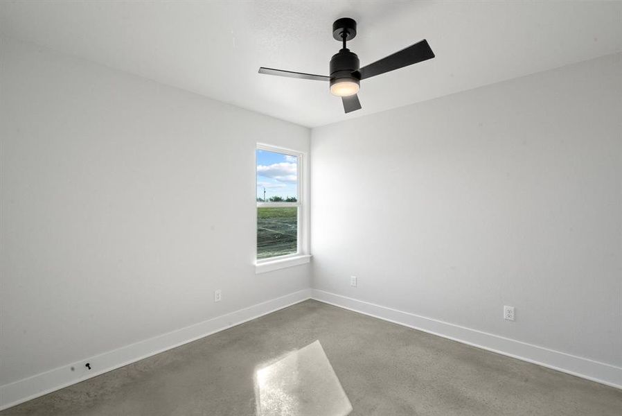 Carpeted empty room featuring ceiling fan