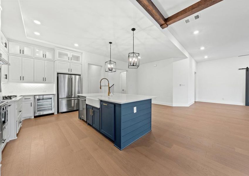 The kitchen has gorgeous white cabinetry with black hardware.