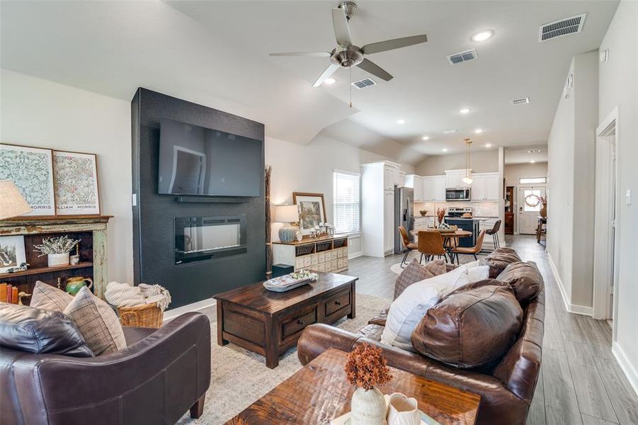 Living room with light hardwood / wood-style floors and ceiling fan