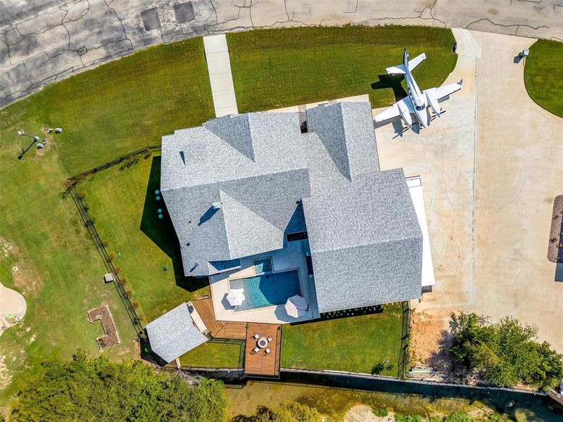 Aerial view of the house and lush backyards.