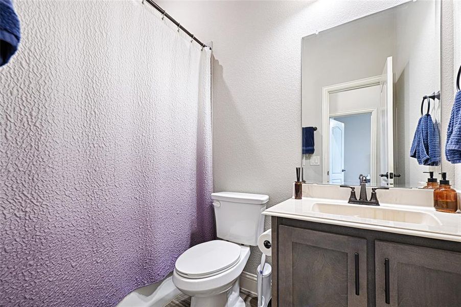 Bathroom featuring vanity and toilet