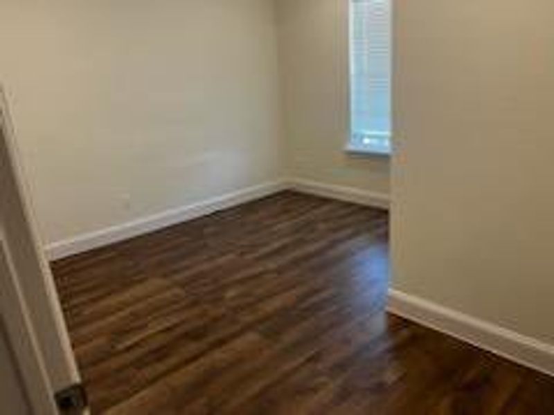 Spare room with dark hardwood / wood-style floors