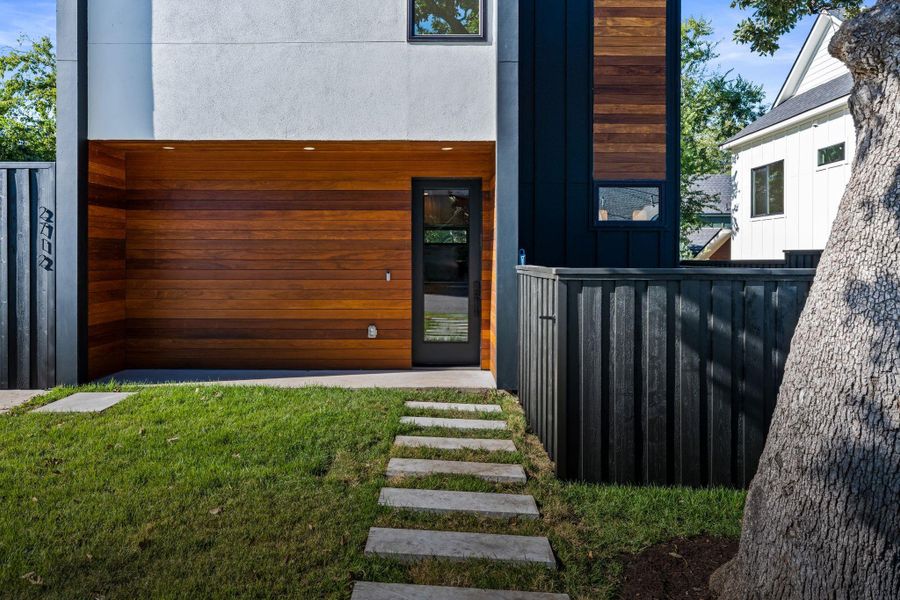 Brazilian teak accent the front facade for a warm and earthy welcome