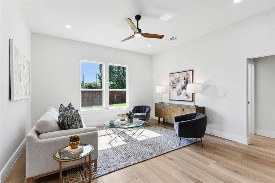 Living room featuring light hardwood / wood-style flooring and ceiling fan