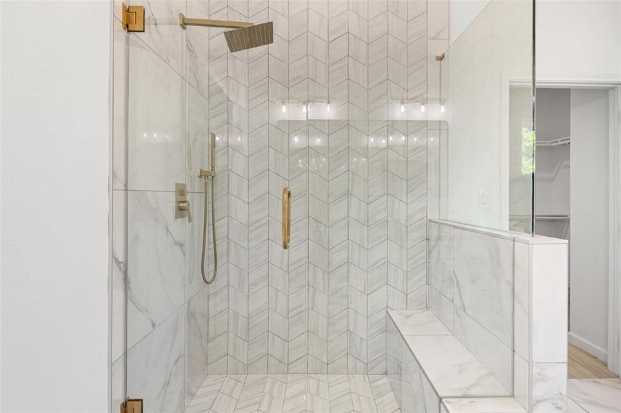 Gorgeous Tile Work In This Shower With A Bench Seat & Rainfall Showerhead