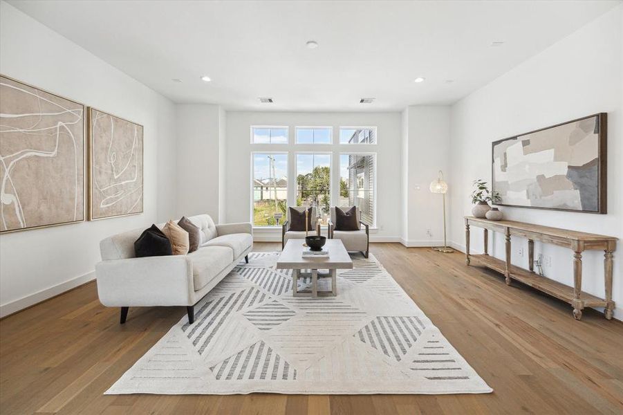 Windows carry light throughout this bright and inviting open living room.