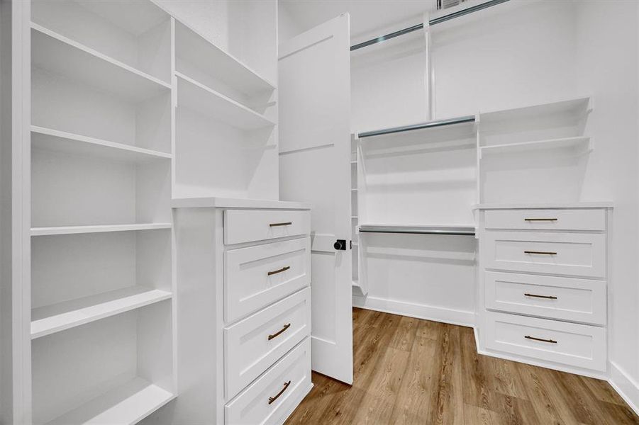 Spacious closet featuring light wood-type flooring