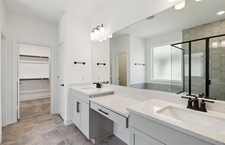 Owner's bath with dual sinks and large shower *real home pictured