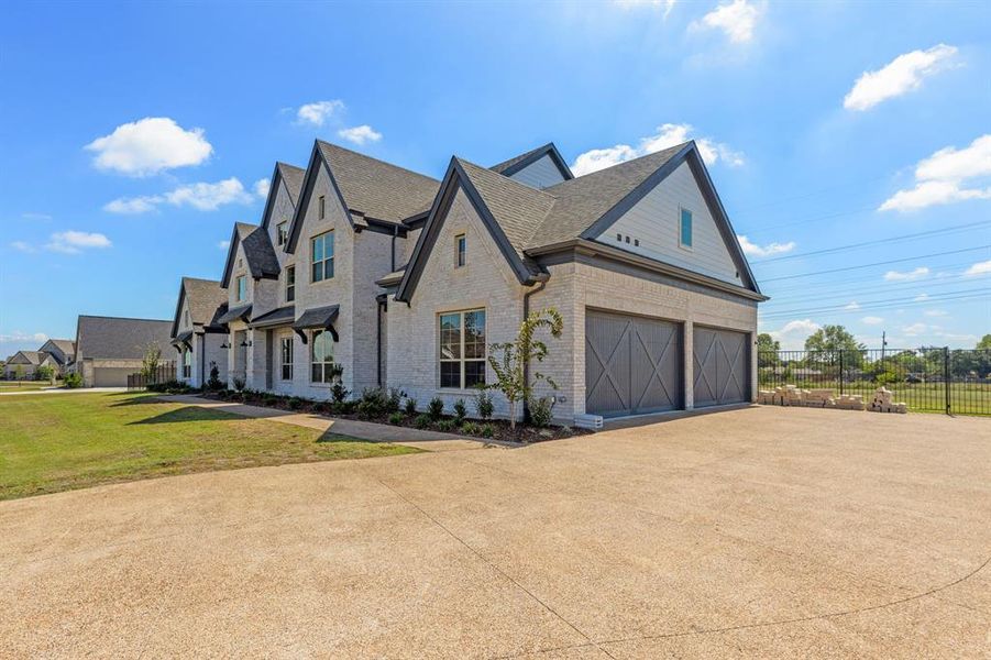 View of property exterior featuring a lawn