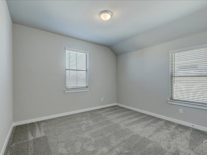 Bedroom in the Mercury home plan by Trophy Signature Homes – REPRESENTATIVE PHOTO