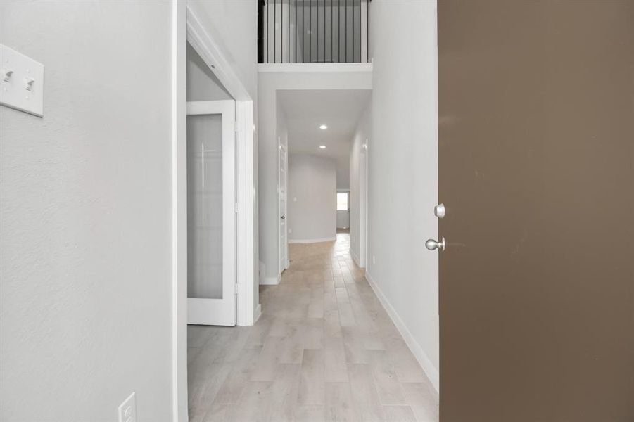 As you step into the threshold of this luxurious home, you'll soon be welcomed by an elegant glass door (to be installed). Inside, soaring ceilings amplify the spaciousness, while the refined wood-look tile flooring and oversized baseboards exude sophistication and charm.